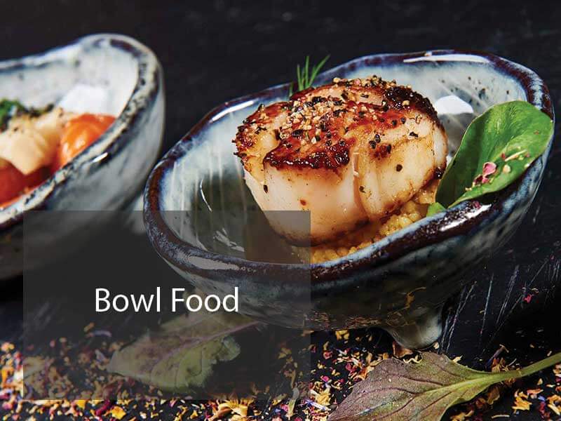 Cooked Scallop on a bed of cuss cuss in a shell designed bowl